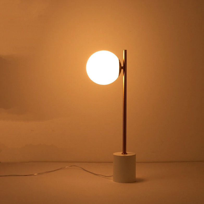 Modernist Marble gold table light with glass sphere